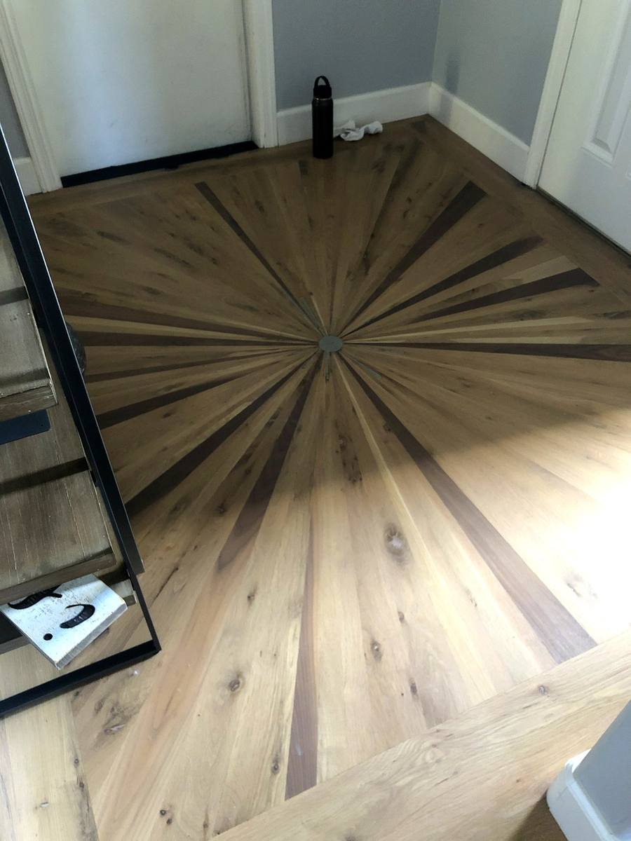 Decorative floor vent on natural hardwood