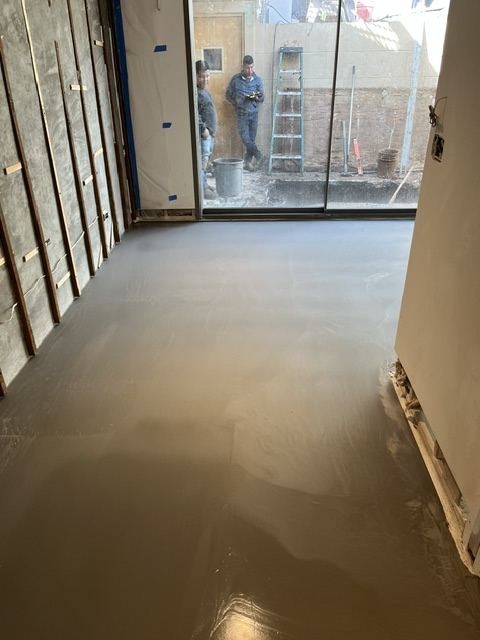 Self-leveling compound poured during floor prep