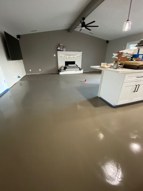 Finished self-leveled concrete floor near fireplace and kitchen island